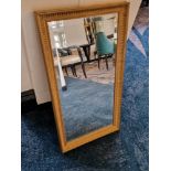 A wooden gilt framed bevelled edge mirror 75 x 40cm