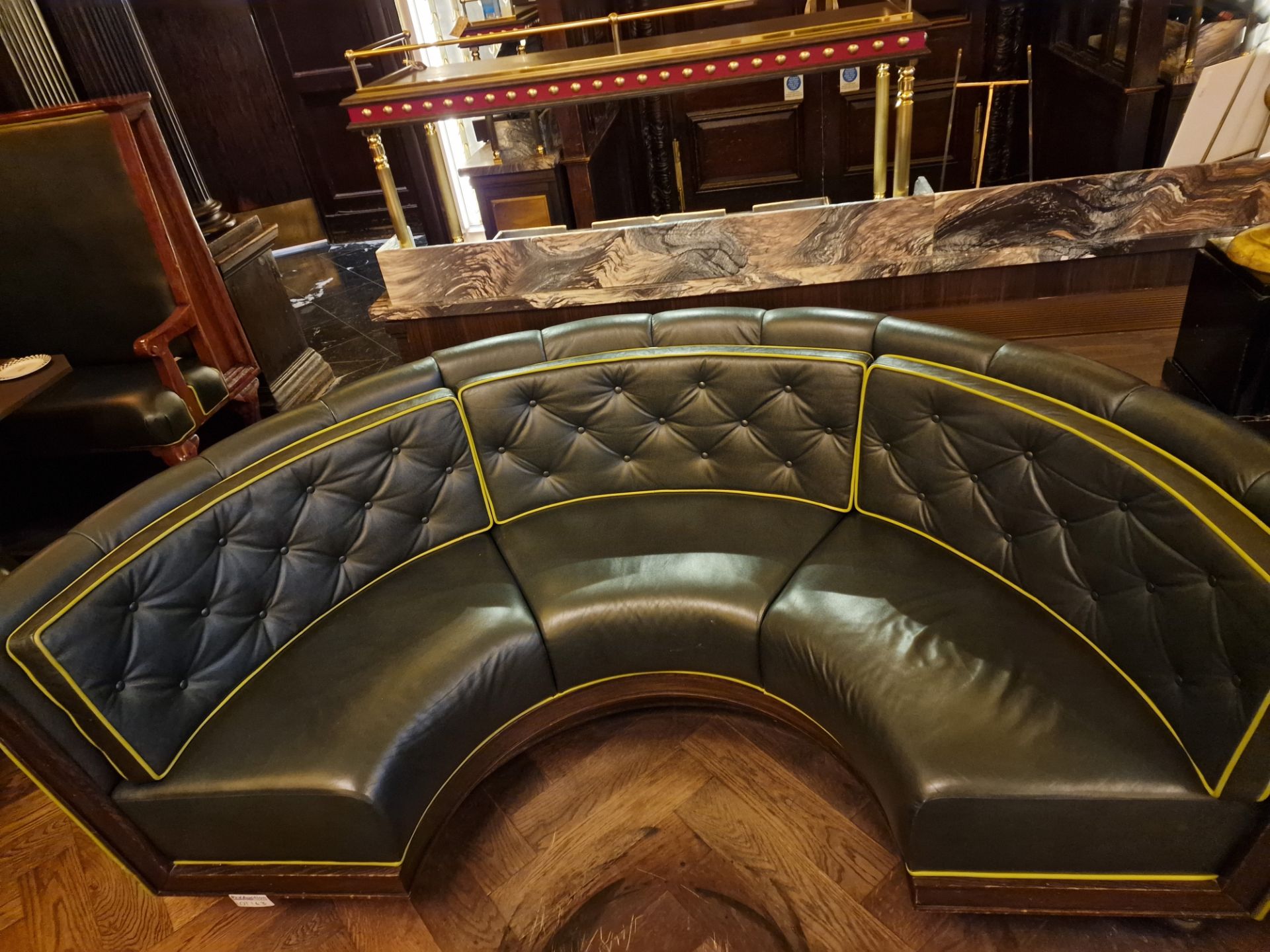 A bespoke Robert Angell tufted leather banquette upholstered in green full leather with piping