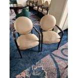 A pair of French style round back armchairs upholstered in champagne gold leather the round back and