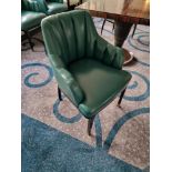 A pair of armchairs upholstered in green leather with a stud pin detailing the arm partially