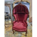 French Porters chair created in the Louis XV style with a mahogany frame and carved rosette details.