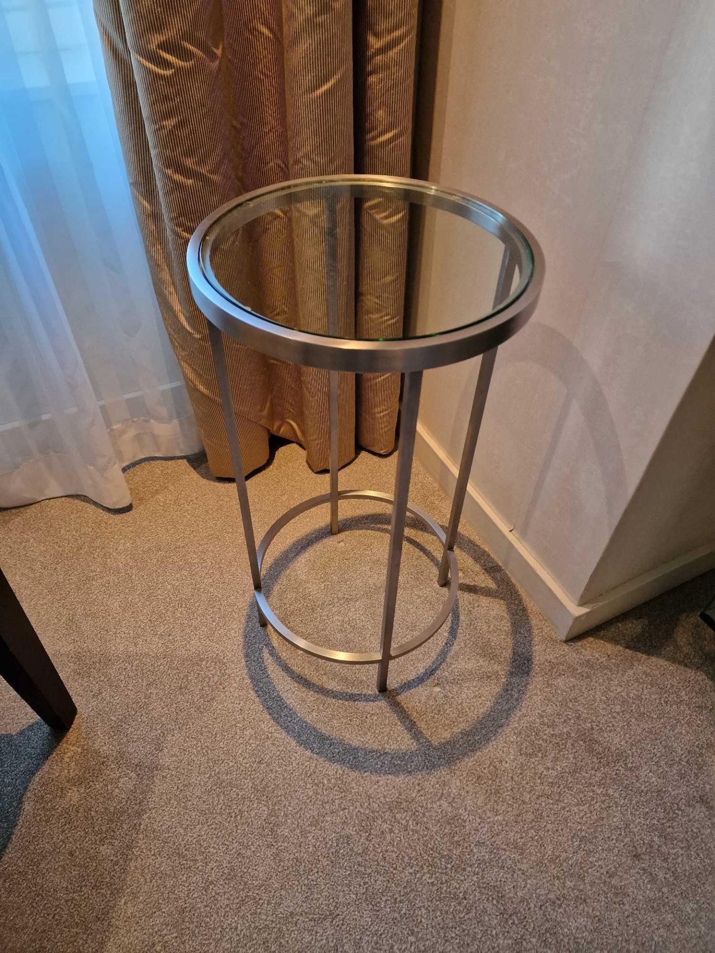 A stainless steel and tempered glass side table 35cm diameter x 64cm tall (Room 2A)