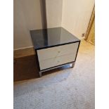 A pair of bedside cabinets by Benhardt black ash mounted glass protective top on stainless steel