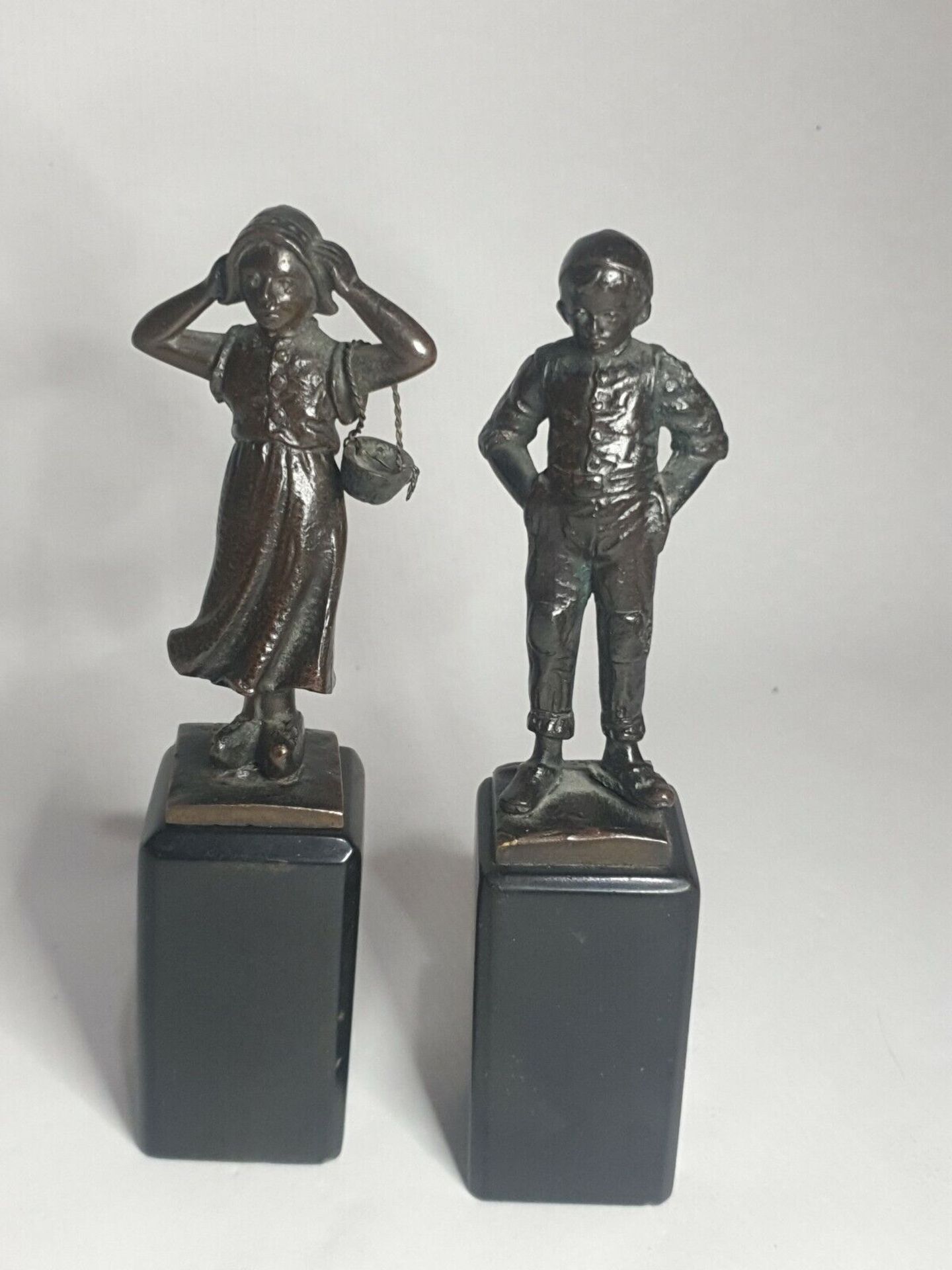 Two early 20th century bronze statuettes of a Dutch boy and girl, German signed to base H.
