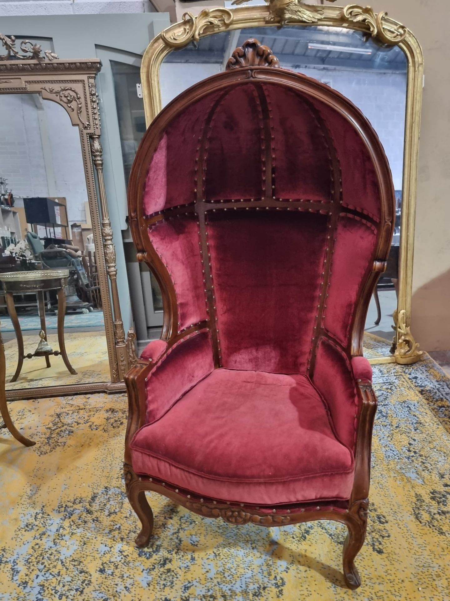 French Porters chair created in the Louis XV style with a mahogany frame and carved rosette details.