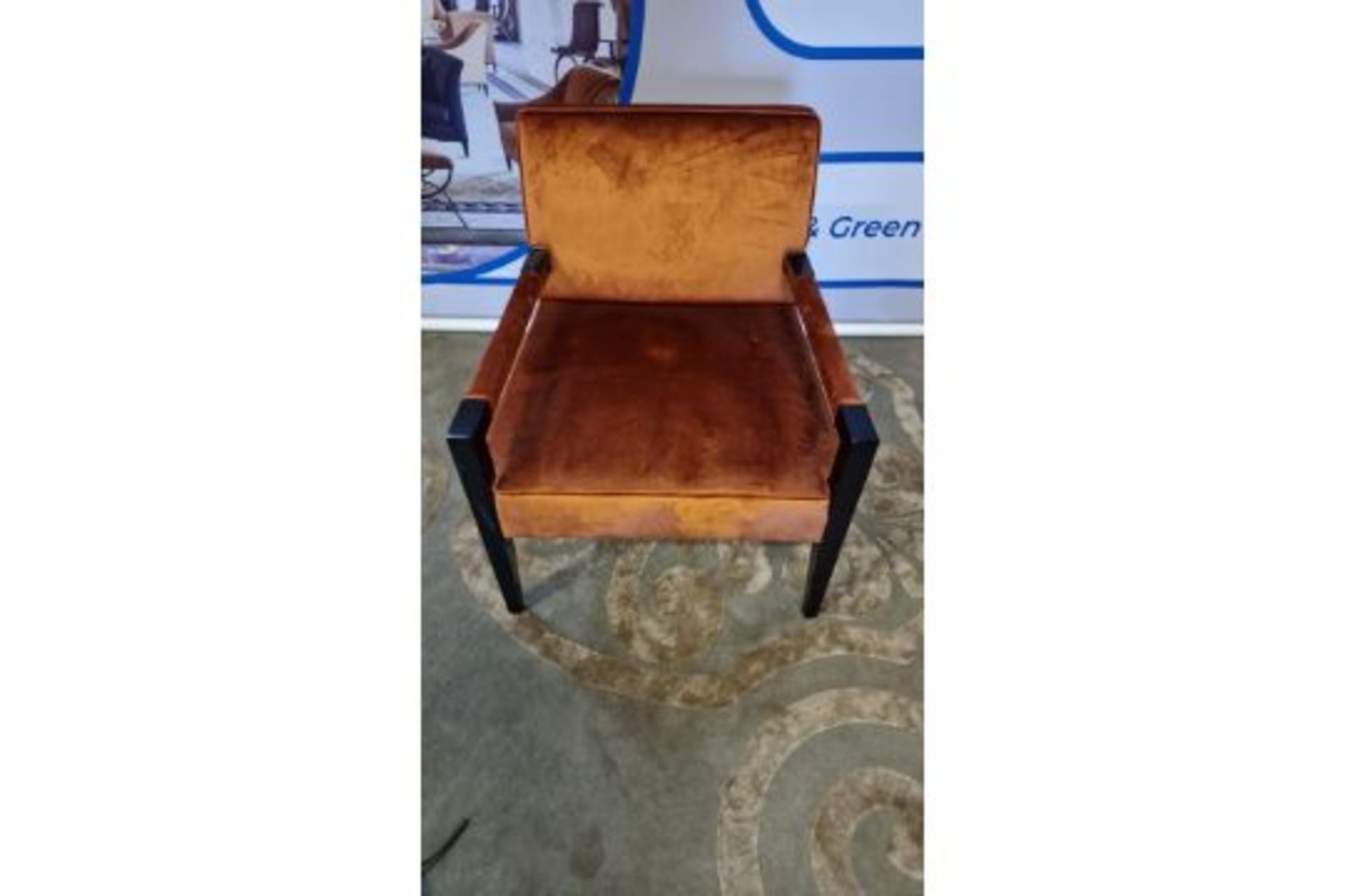 Copper upholstered arm chair with padded arms on a dark wooden frame with tapering legs 60 x 70 x