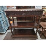 Victorian carved oak three tier buffet, the rectangular top above a single freeze drawers carved