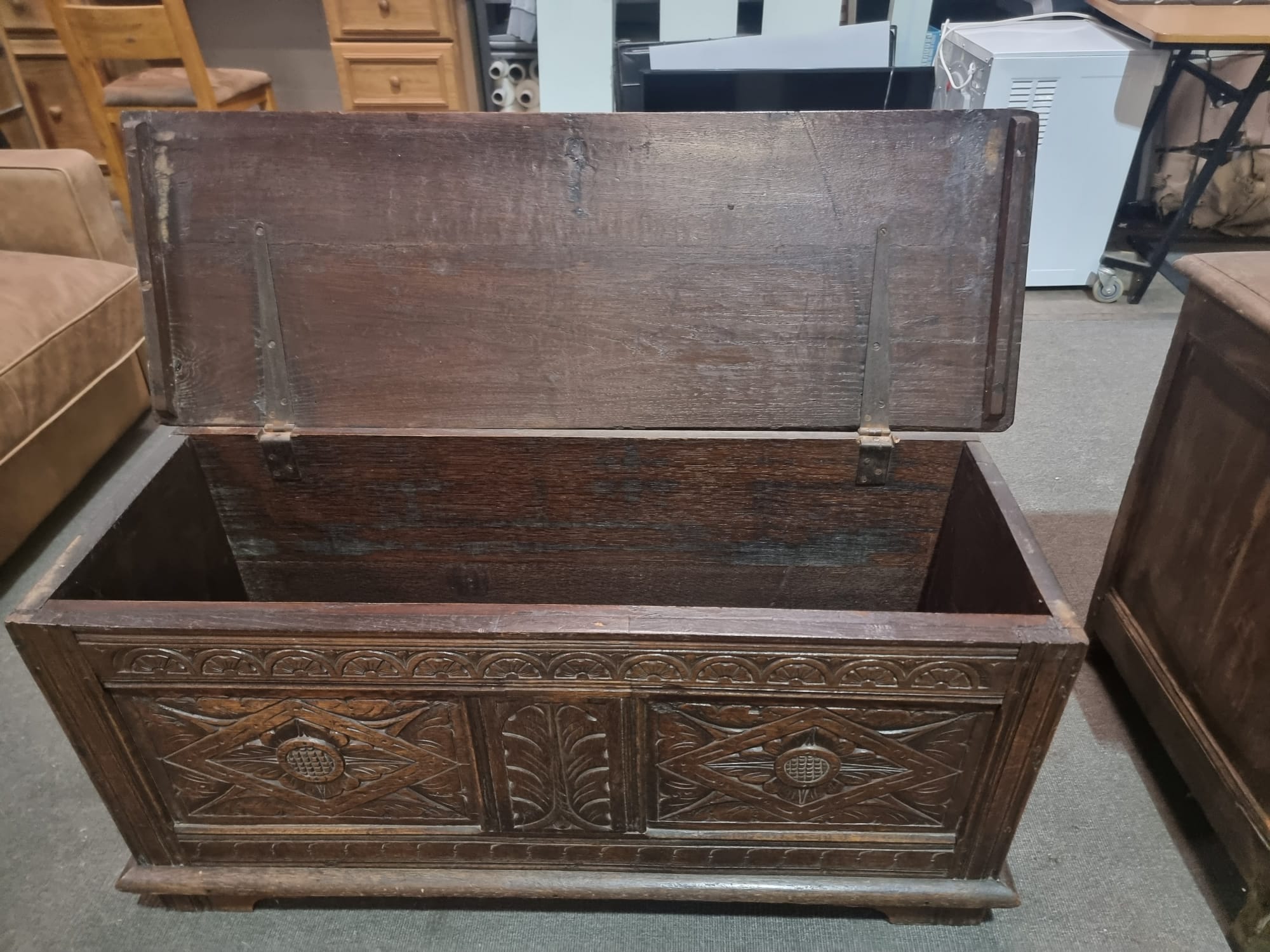 Late 18th Century style oak coffer the plank top above three geometrically carved panels on the