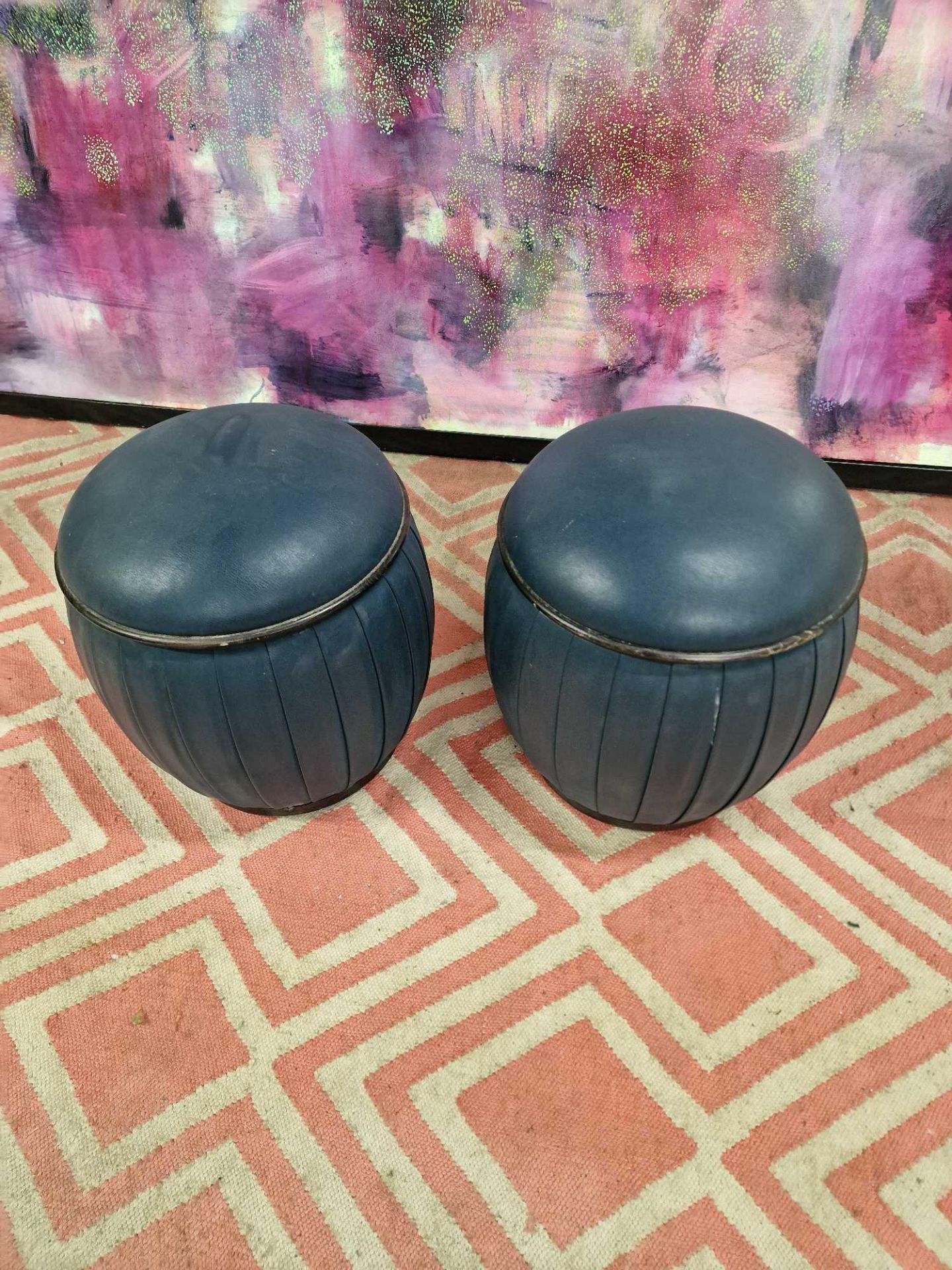 A pair of upholstered blue leather drum ottoman stools 37 x 42cm