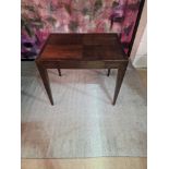 A panelled top mahogany writing table with single drawer and glass protective top on square fluted