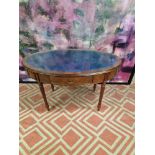 Oval writing table with blue tooled leather inlay under a protective glass top, the apron features