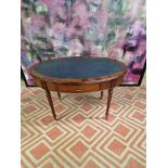 Oval writing table with blue tooled leather inlay under a protective glass top, the apron features