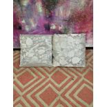 A pair of Silver silkeen patterned cushions 45 x 45cm