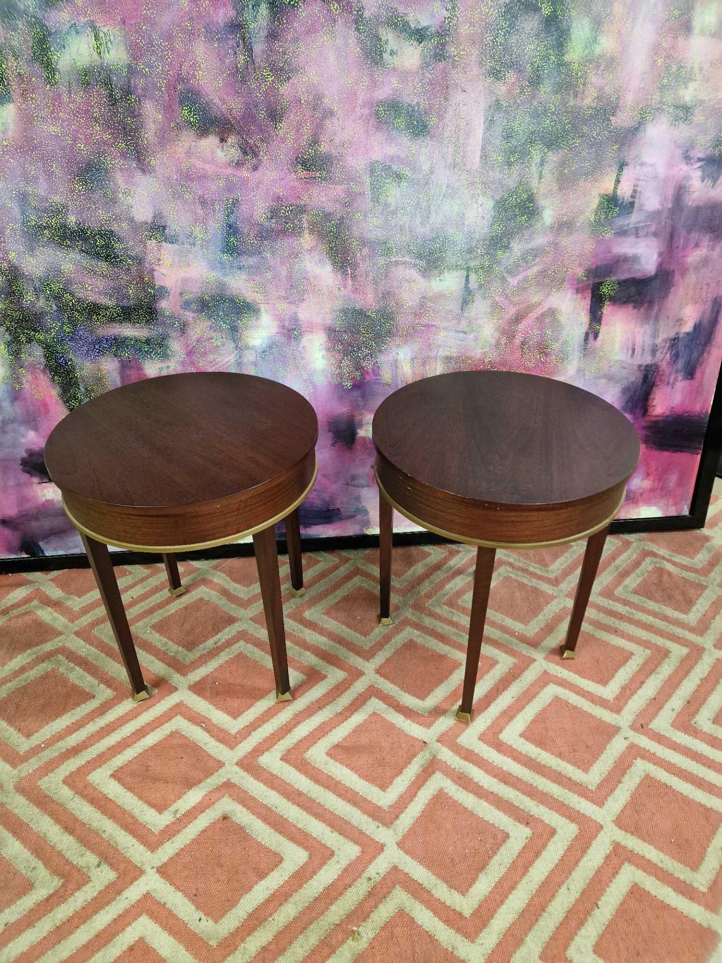 A pair of mahogany drum side tables the circular top 55cm wide with a brass trim detail on square