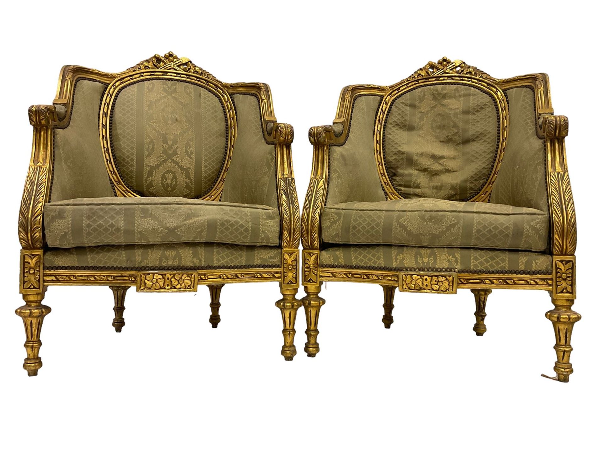 A Pair Louis XVI design gilt framed armchairs, the cresting rail pierced and moulded with flower