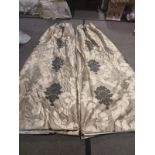 A pair of silk drapes gold with black floral pattern fully lined pencil pleat top each panel 180cm