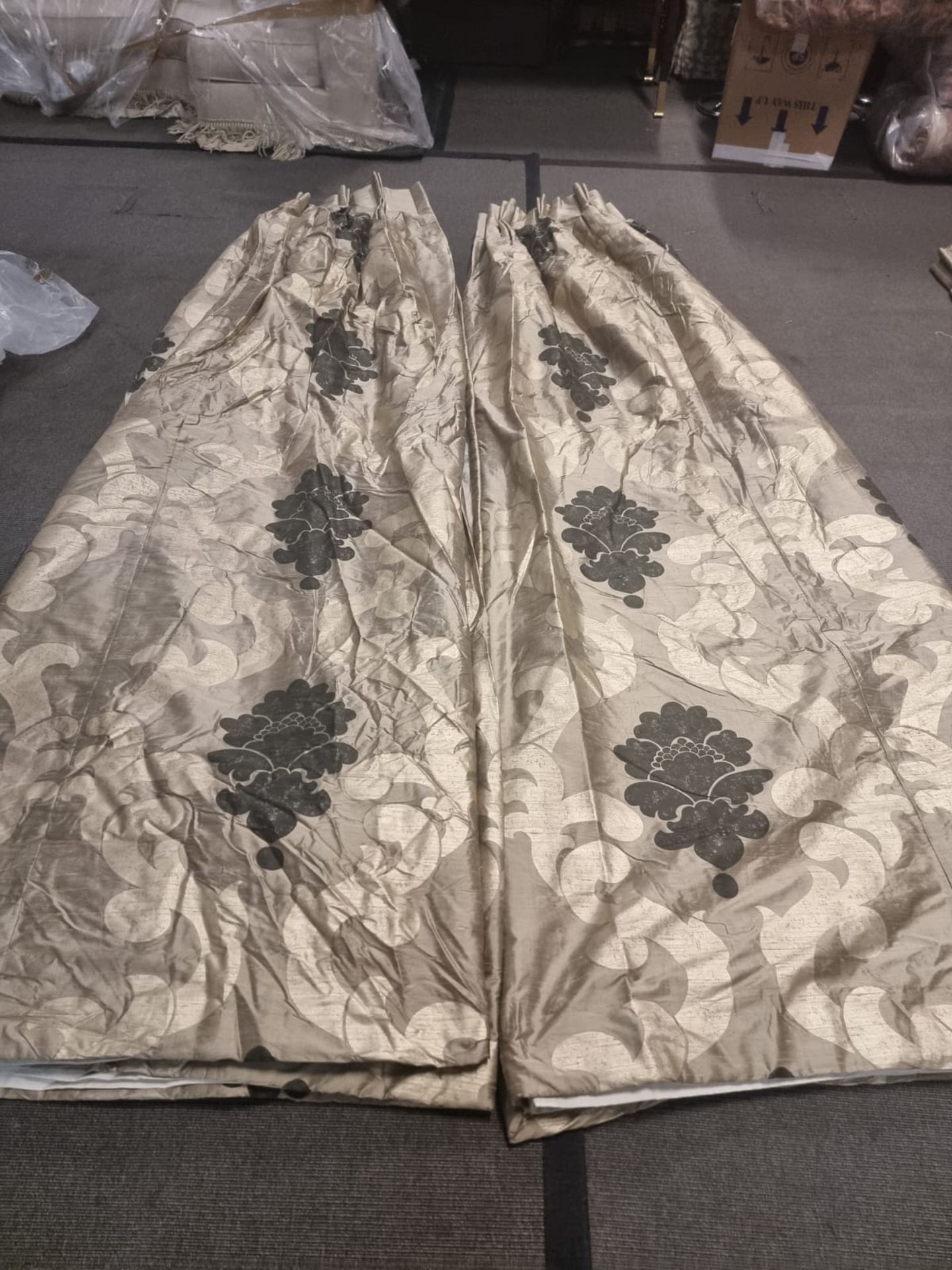 A pair of silk drapes gold with black floral pattern fully lined pencil pleat top each panel 180cm