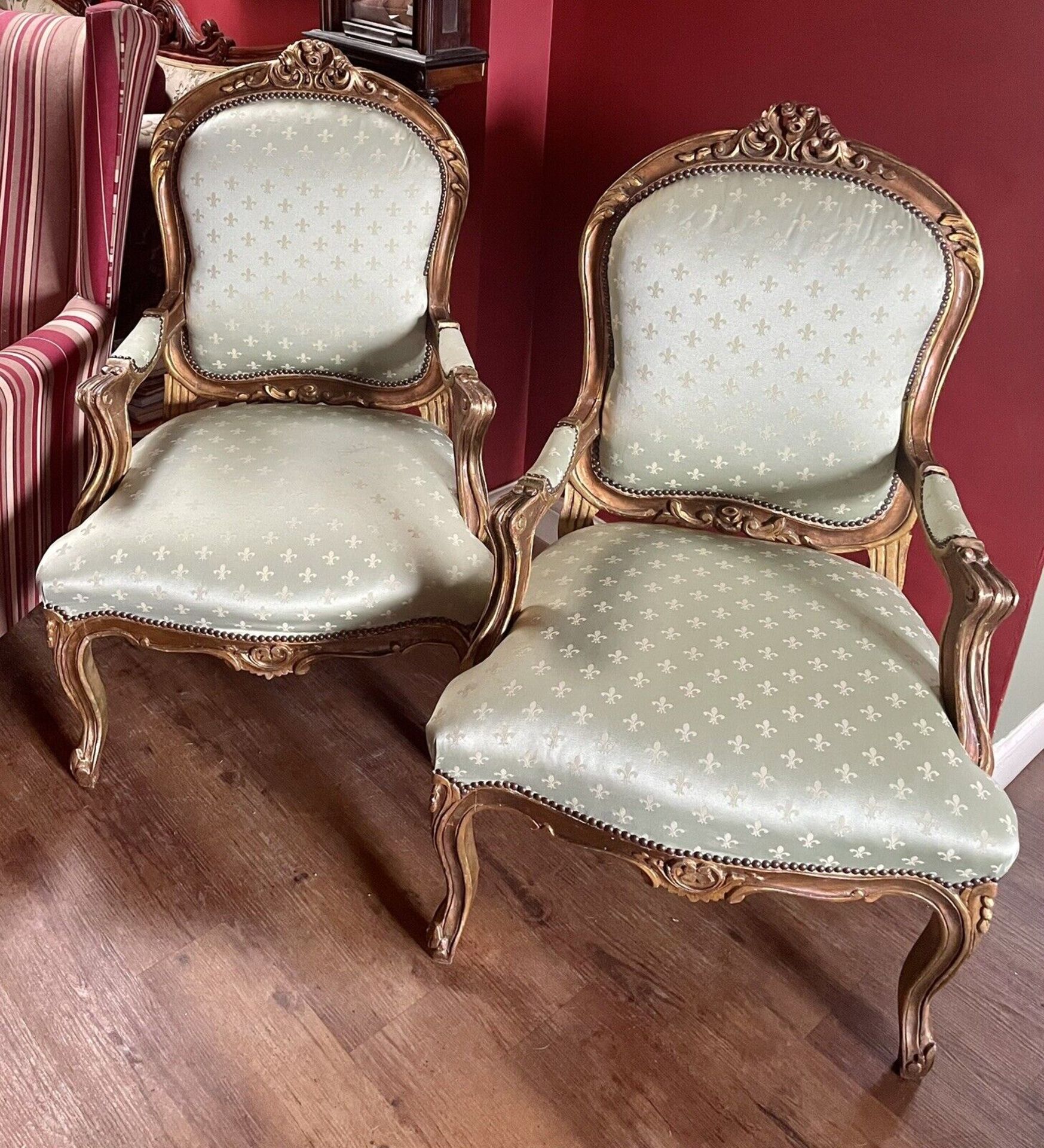 A Pair of Fauteuils In Louis XVI Style Carved Gilt Wood Arm Chairs Upholstered In Fleur De Lys