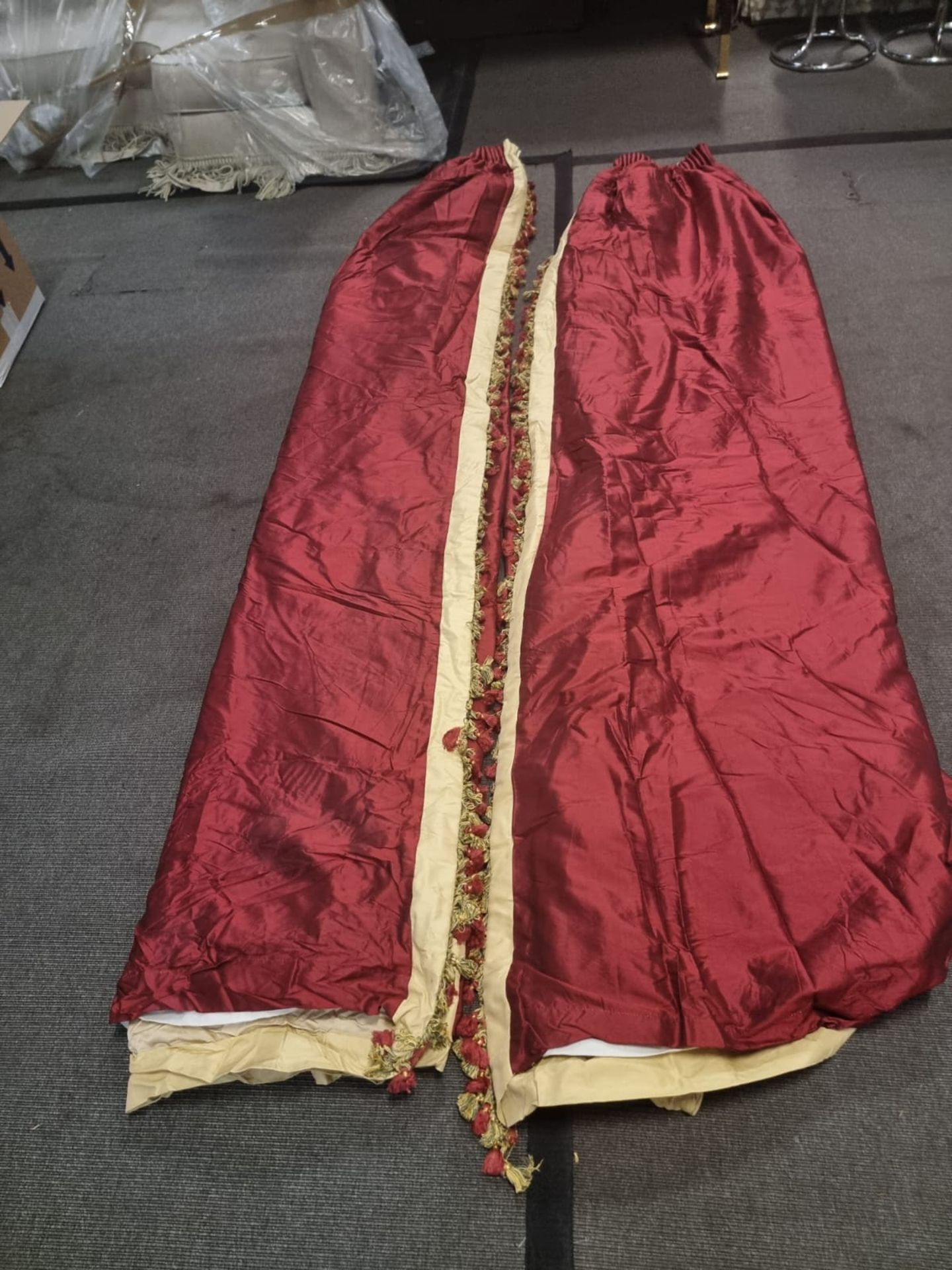 A pair of silk red and gold drapes pencil pleat with tassel fringe each panel 64cm wide x 260cm drop