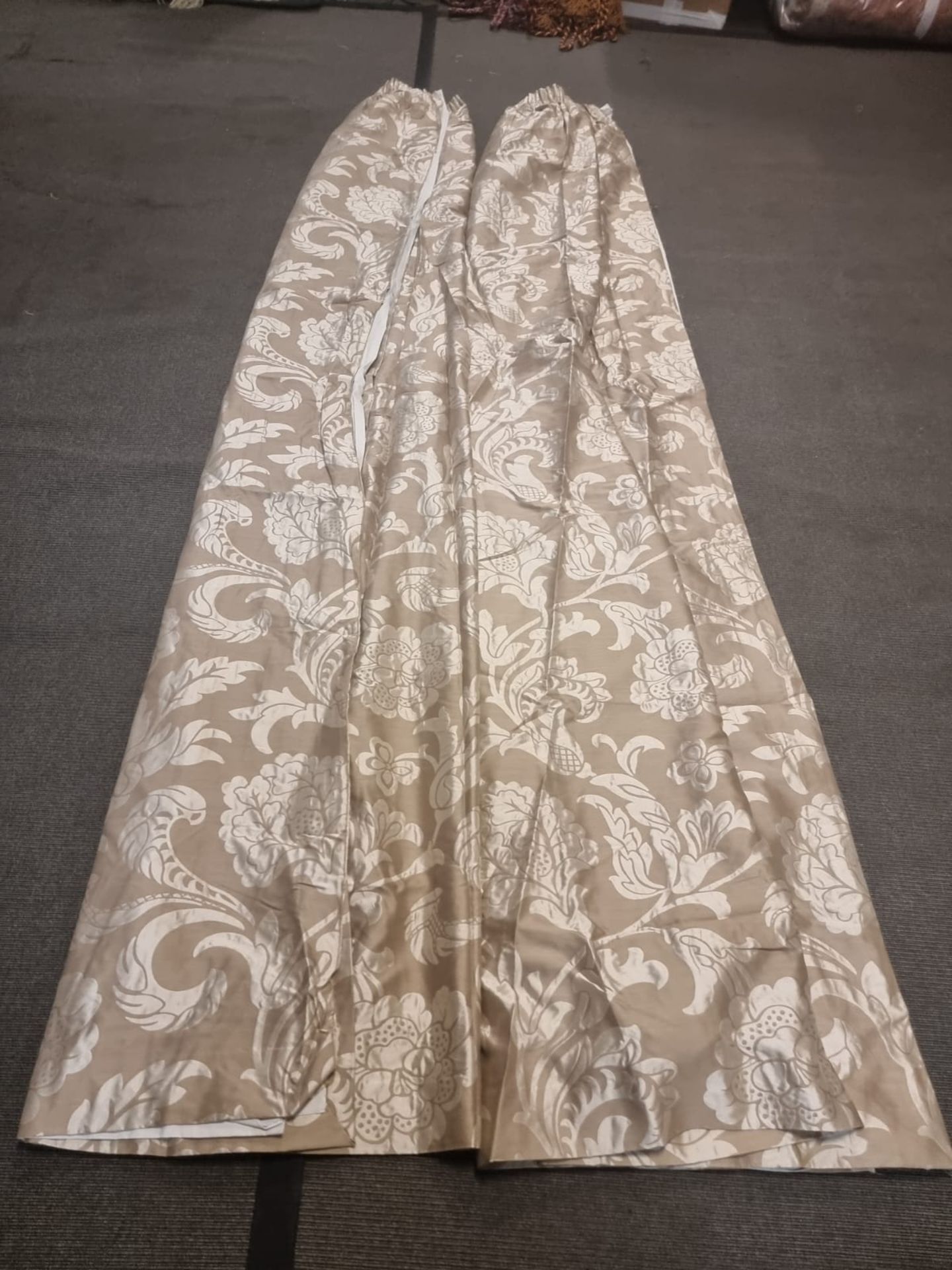 A pair of silk drapes gold with floral subtle pattern fully lined each panel 110cm wide x 310cm drop
