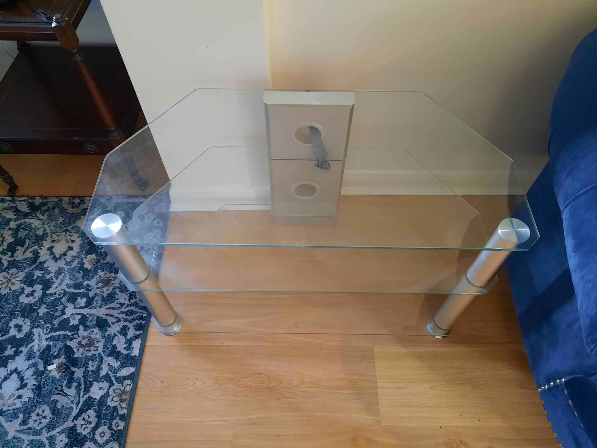 A Two Tier Glass Corner TV Unit - Clear & Chrome This Contemporary Entertainment Unit Features Clear