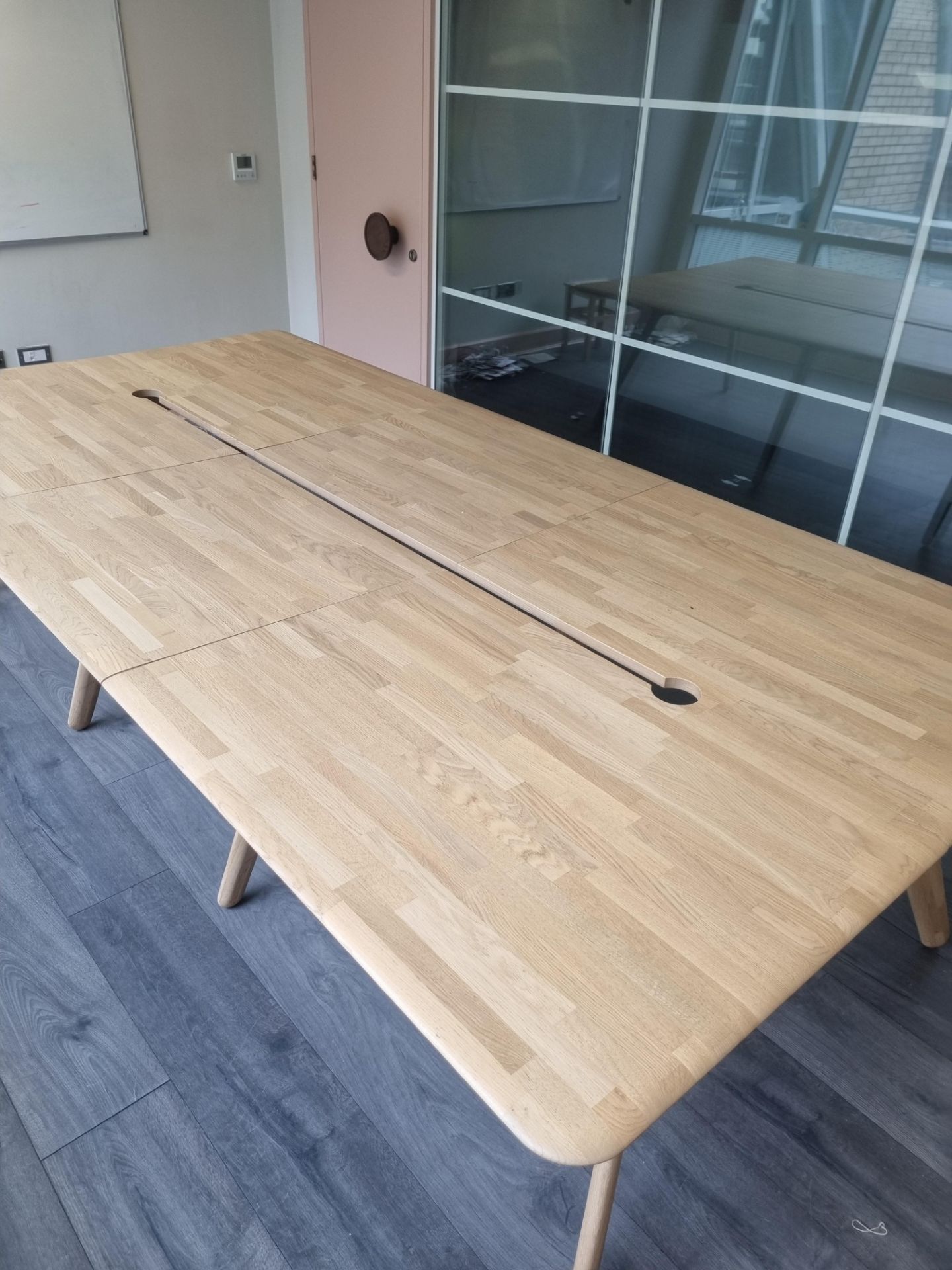 A Contemporary Hardwood Boardroom Table Mounted On Eight Scandi Form Legs With Central Void For