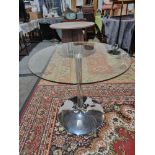 Glass And Stainless Pedestal Round Dining Table. Clear Tempered Glass Tabletop And A Smooth,