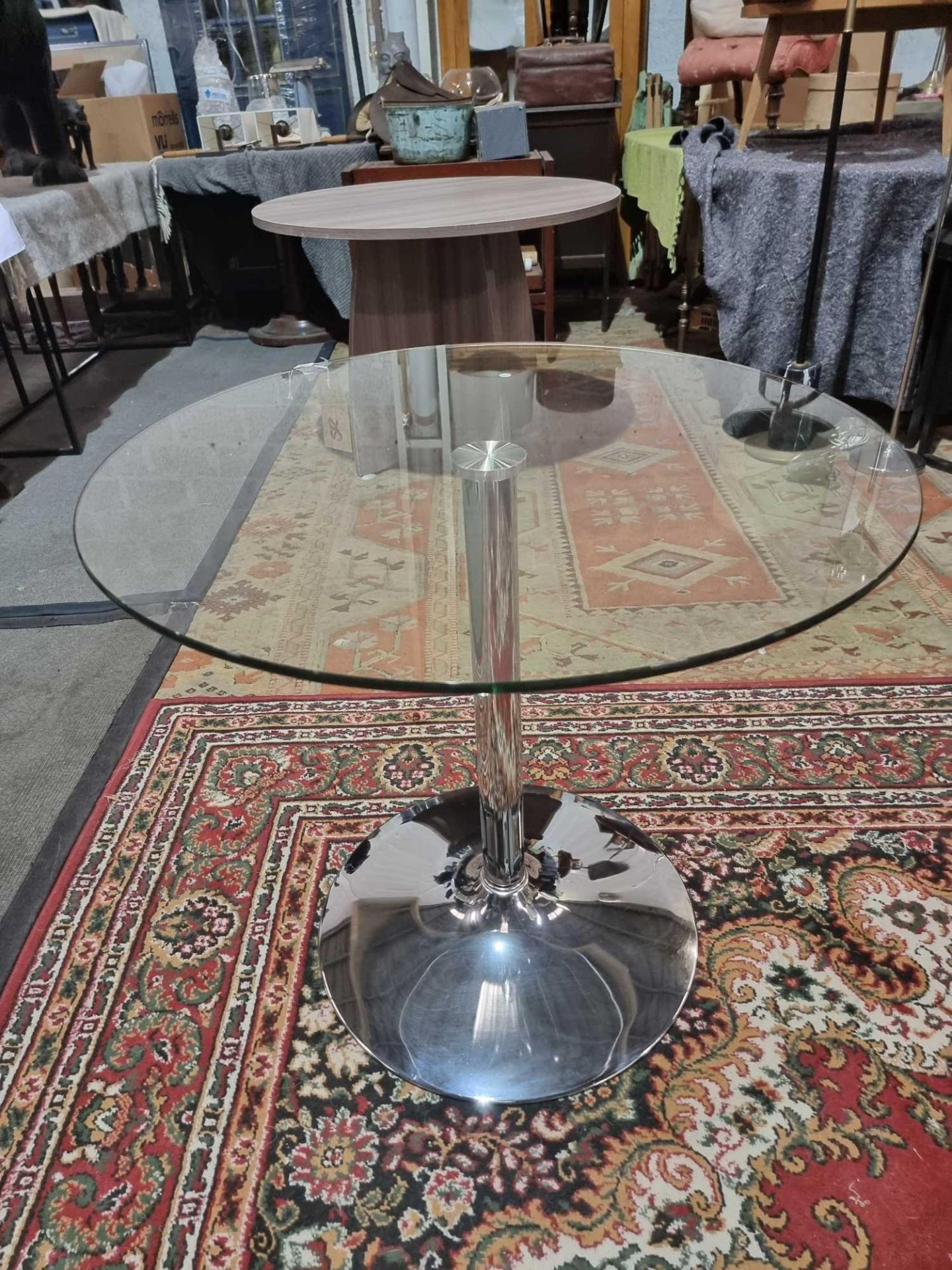 Glass And Stainless Pedestal Round Dining Table. Clear Tempered Glass Tabletop And A Smooth,