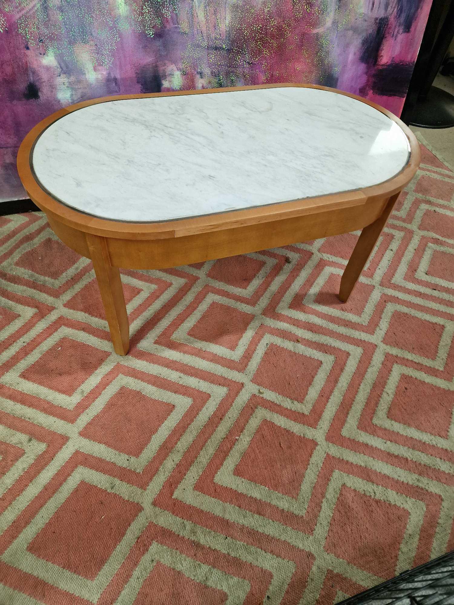 Coffee table oak oval table with a white marble top inset enhanced by silver metal trim 100 x 55 x