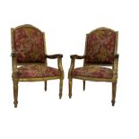 A Pair Louis XVI design gilt framed armchairs, the cresting rail moulded with flower heads and