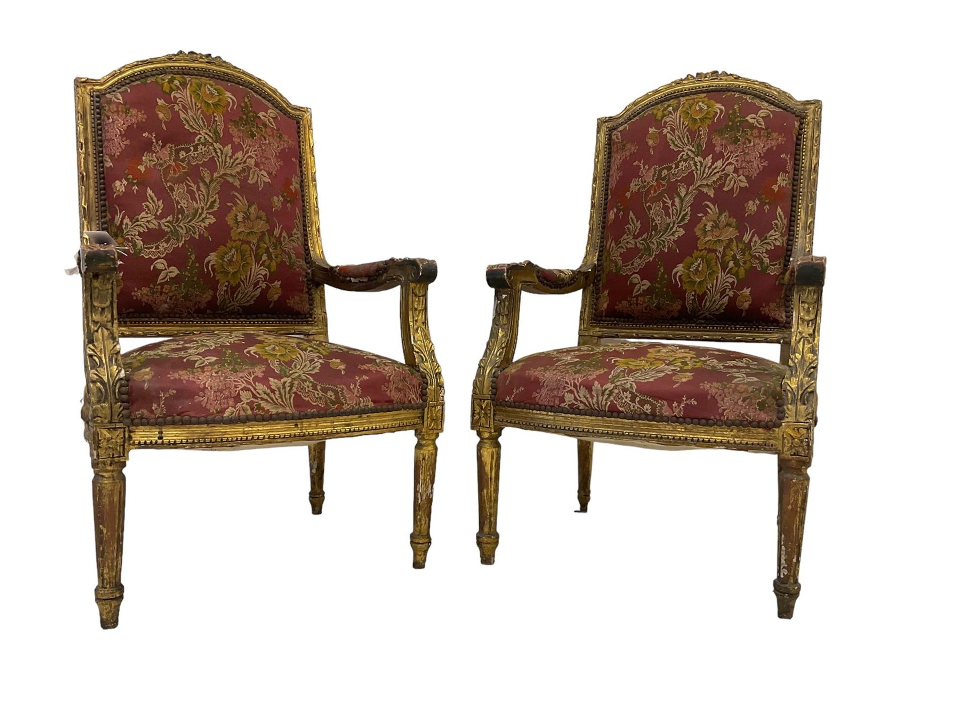 A Pair Louis XVI design gilt framed armchairs, the cresting rail moulded with flower heads and
