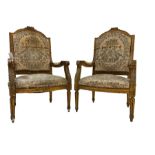 A Pair Louis XVI design gilt framed armchairs, the cresting rail moulded with roses, scrolled arm