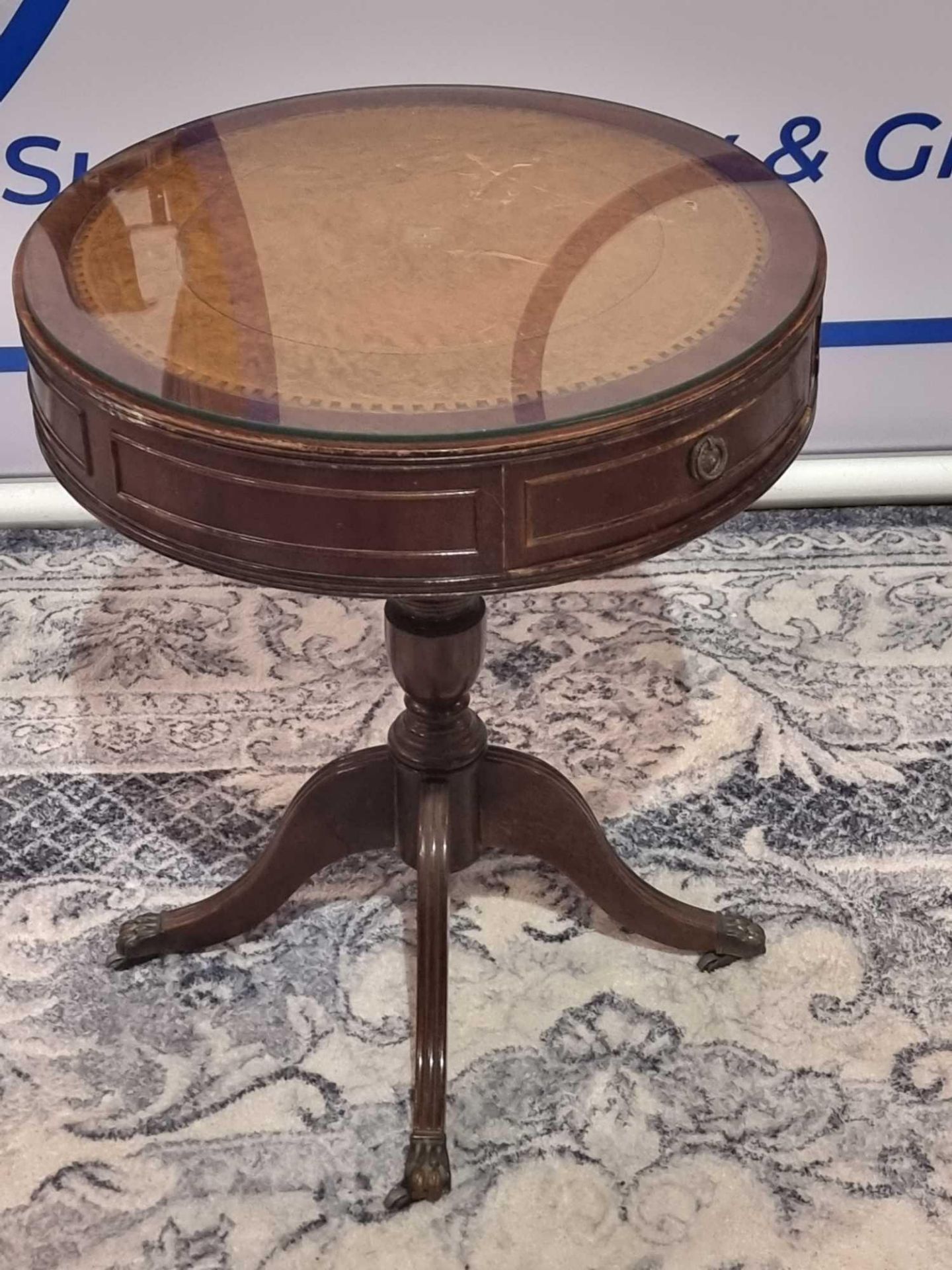 A Regency Style Mahogany Drum Table With Leather Inlay Top And Glass Protector Over The Apron