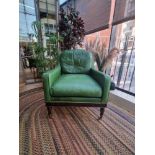 A  Green Leather upholstered vintage armchair on castor front legs reupholstered in a racing green