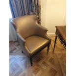 A Modern Wing Back Chair Upholstered In Gold Leather With Pin Stud Detail On Dark Solid Wood Frame
