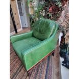 A  Green Leather upholstered vintage armchair on castor front legs reupholstered in a racing green