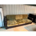 Slender and simple tuxedo style three-cushion sofa in gold velvet upholstery the frame in brown