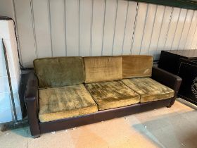 Slender and simple tuxedo style three-cushion sofa in gold velvet upholstery the frame in brown