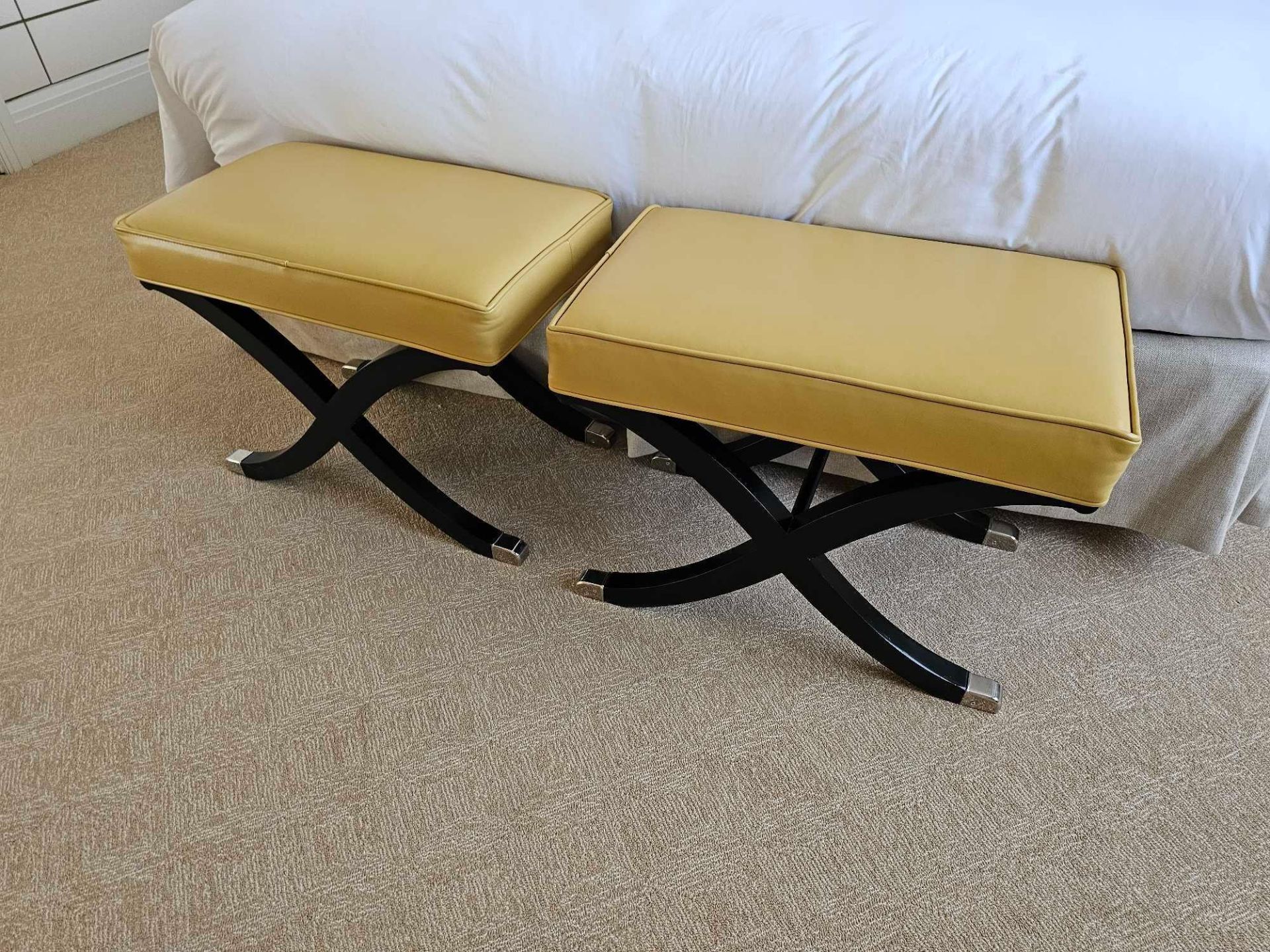A Pair of Leather Stools taking inspiration from the design of Andre Arbus these caramel leather