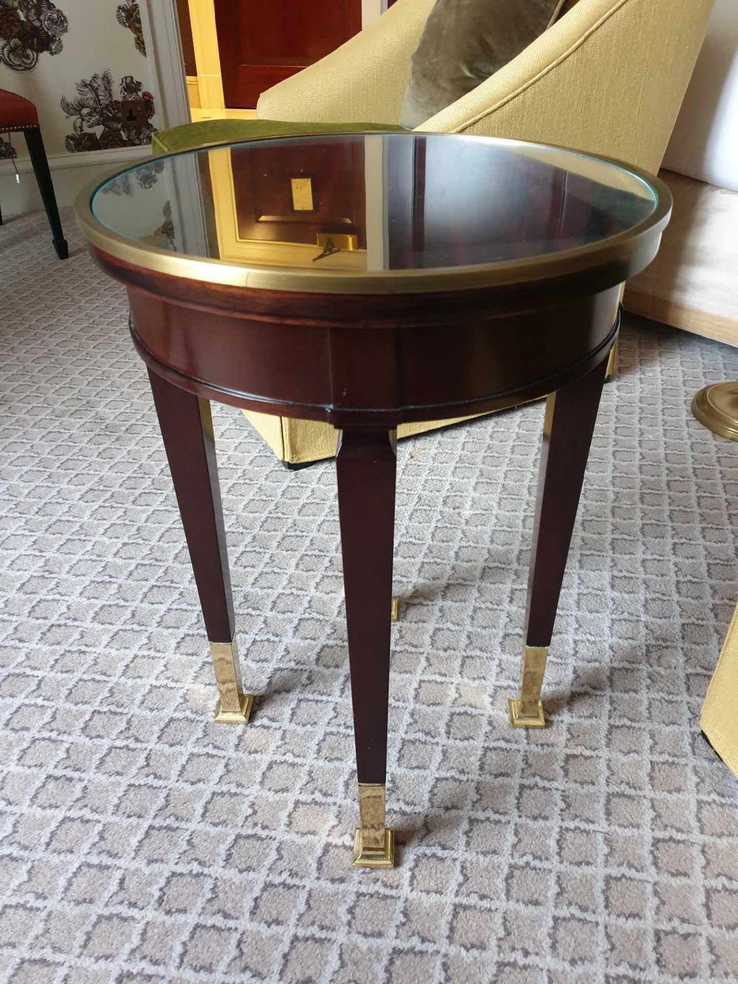 Circular Side Table With Antiqued Plate Top And Brass Trim Mounted On Tapering Legs With Brass