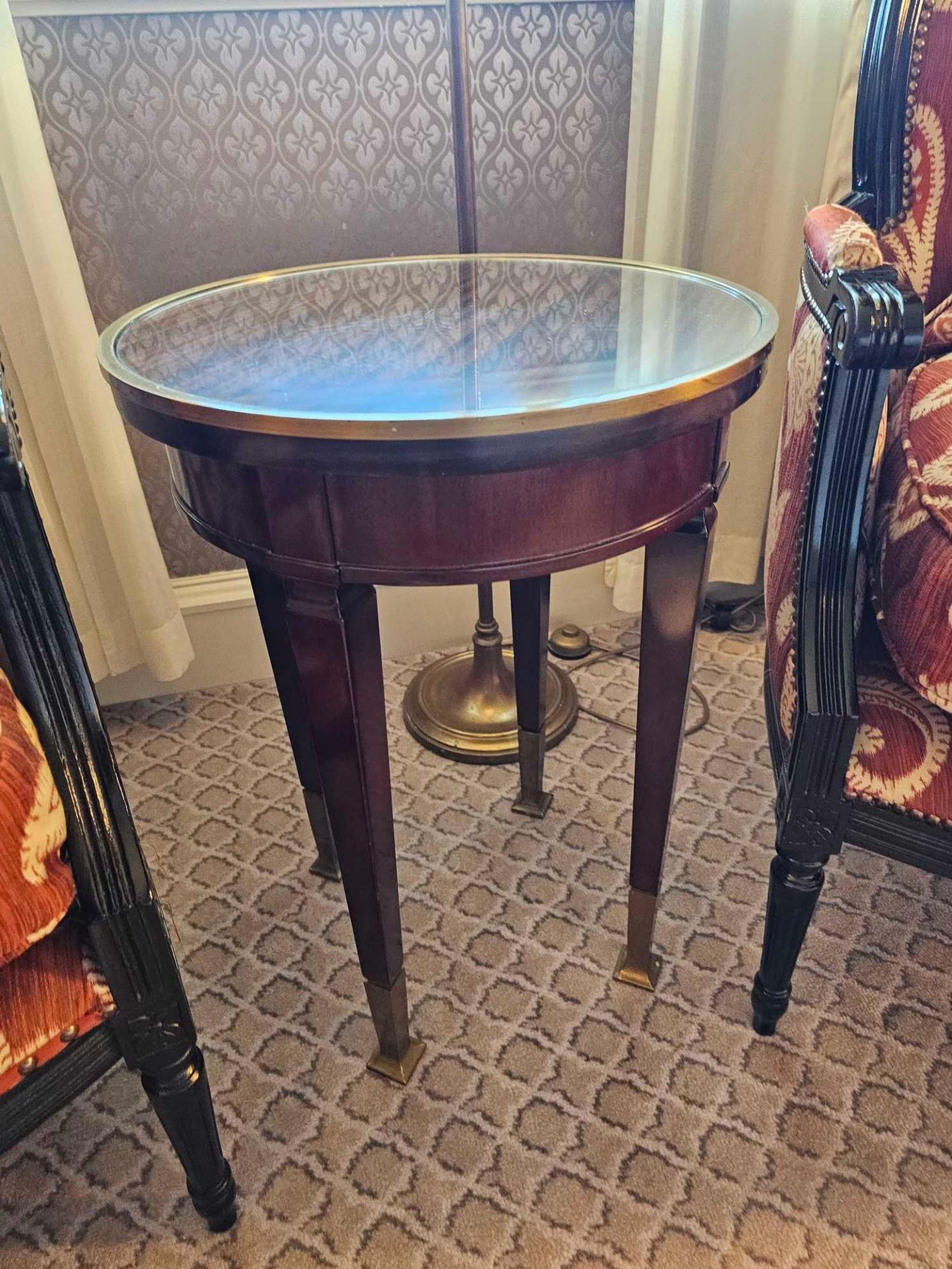 Circular Side Table With Antiqued Plate Top And Brass Trim Mounted On Tapering Legs With Brass