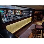 Bar counter with back bar system a wooden structured unit with black stone top with a faux marble