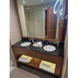 A stone top black double basin vanity unit with Vitra porcelain basins and Hansgrohe Blend Single