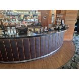 Bar counter with back bar system a wooden structured unit with black stone top with a faux leather