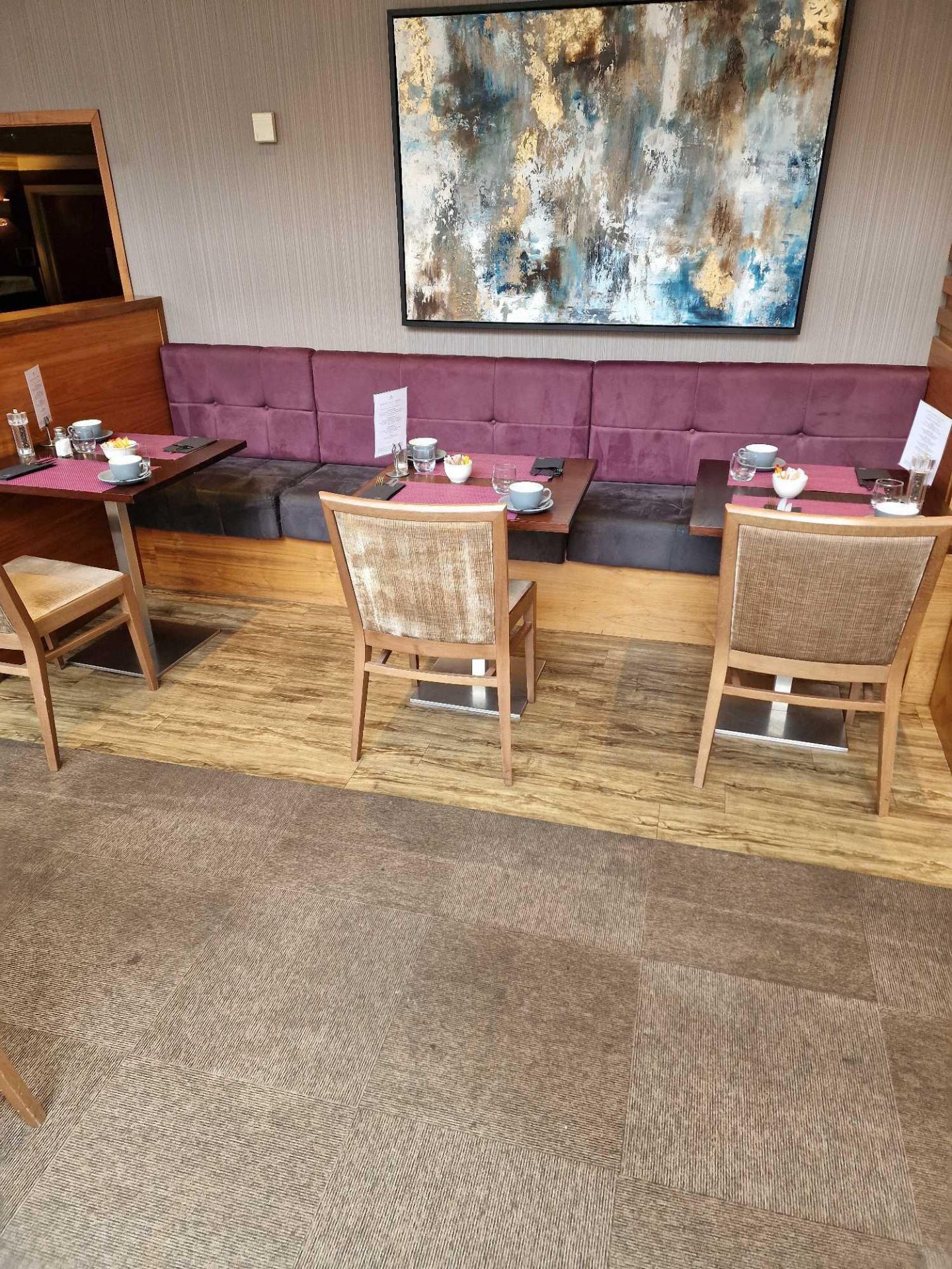 Banquette seating straight run n a mauve and grey upholstered suede effect fabric seats