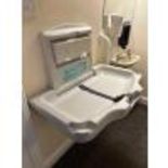 Folding wall mounted. Baby changing station with sanitary covers in dispenser.