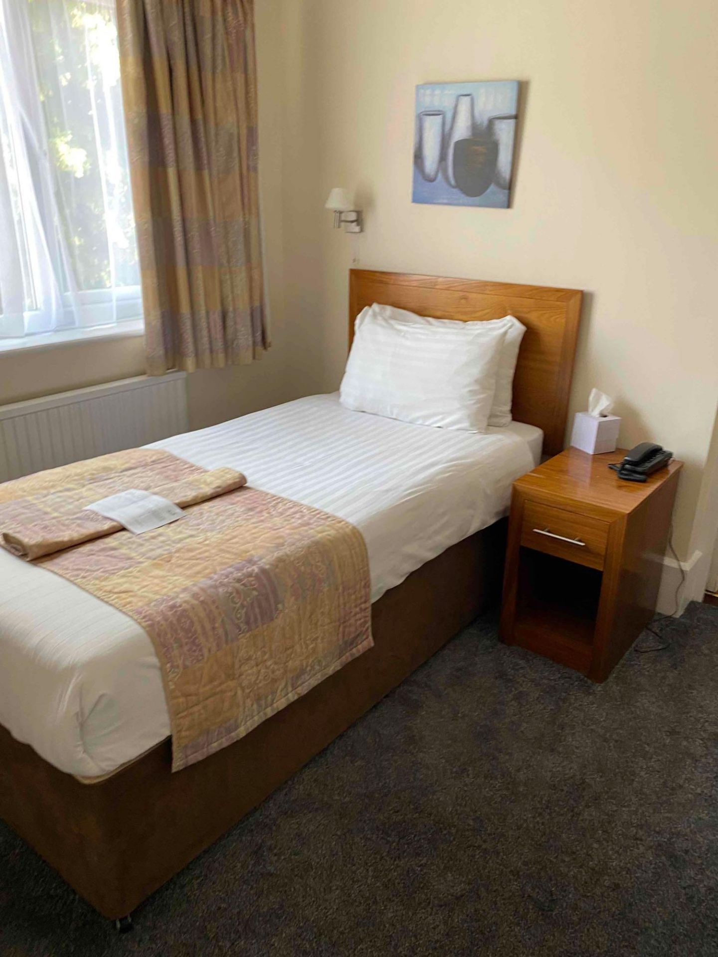 Contents of guest bedroom number 2 at the Brookfield Hotel. Darkwood bedroom desk with 3 drawers and