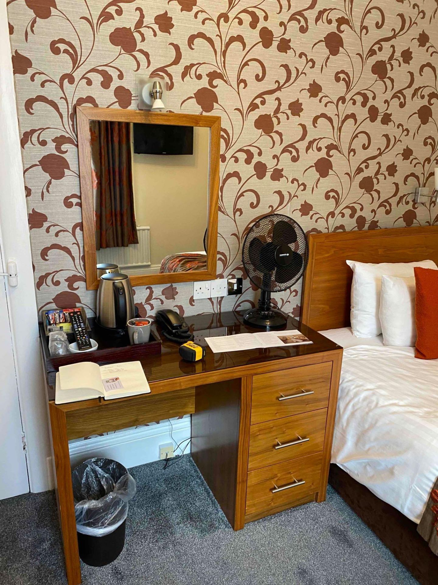 Contents of guest bedroom number 1 at the Brookfield Hotel. Darkwood bedroom desk with 3 drawers and
