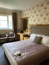 Contents of guest bedroom number 33 at the Brookfield Hotel. Darkwood bedroom desk with 3 drawers