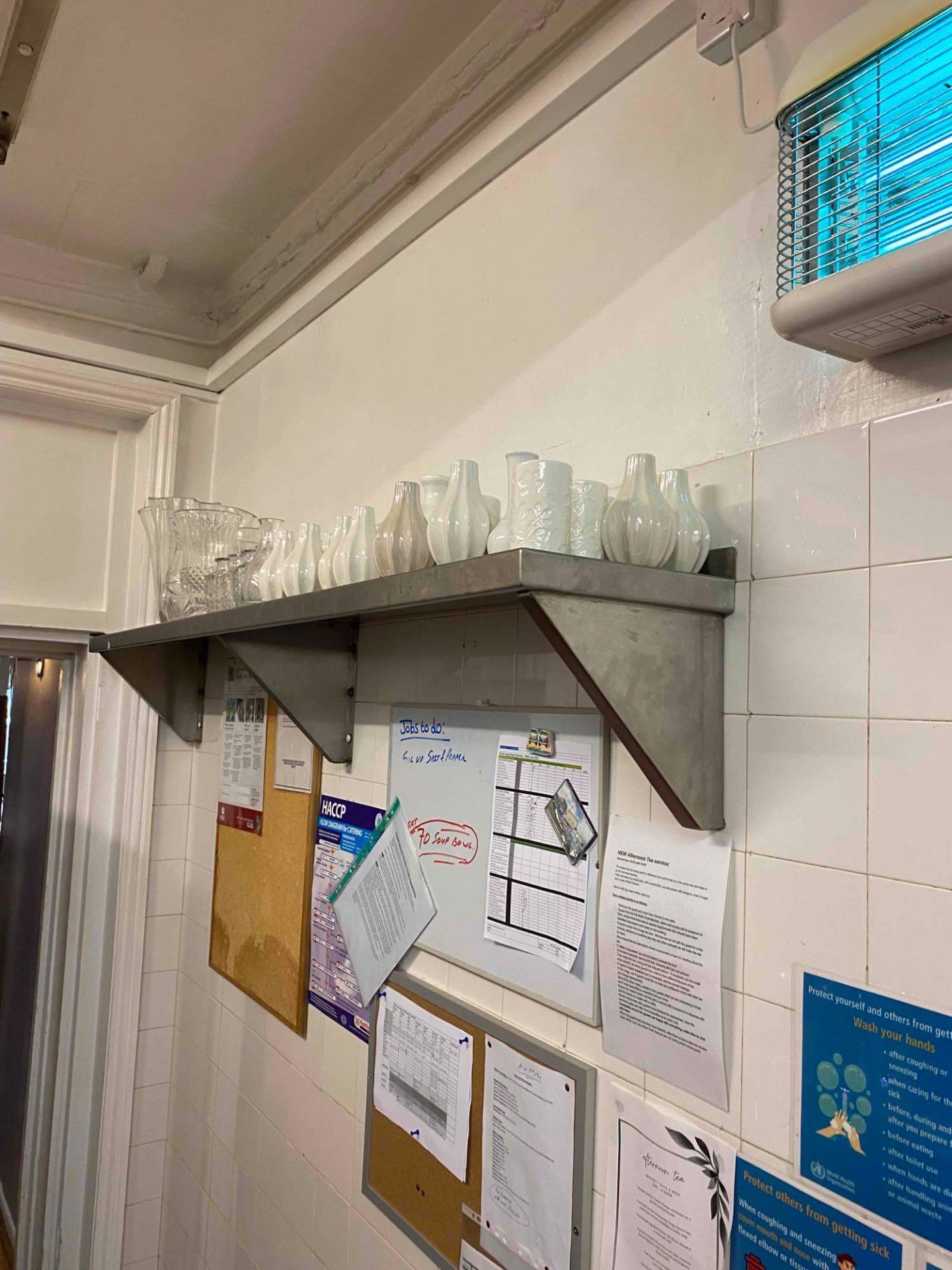 Contents of metal wall shelf as found to include various vases.